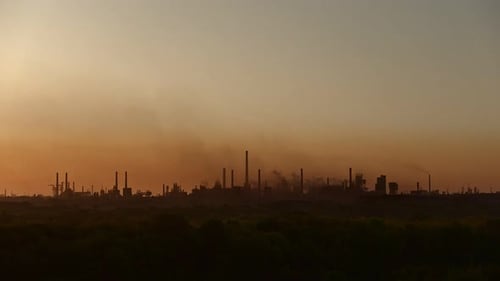 Silhouette of a Large Industrial Plant Polluting Environment with Emissions