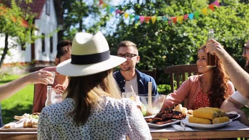 Friends Toasting and Eating at Backyard Barbecue
