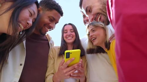 Happy Group of People Using Having Fun Using Smartphones at City Street