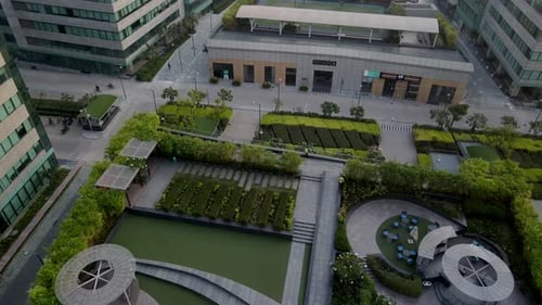 Aerial Drone View of Modern Glass Office Towers in Gurgaon, India – Lush Green Corporate Campus