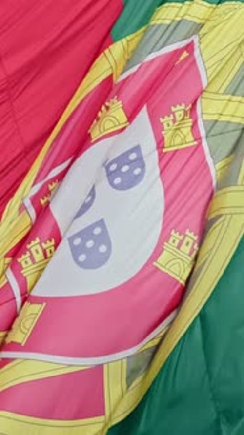 Closeup of Big National Flag of Portugal Waving in the Wind on Clear Sunny Day at Blue Sky Real
