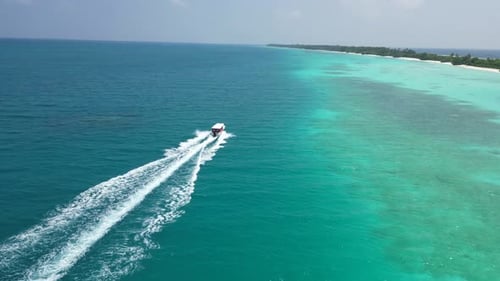Stunning Blue Ocean Aeral View Tourist Yacht Plows the Ocean Fun and Vacation on Maldives