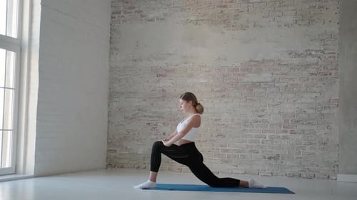 Slender Flexible Sportswoman Stretching Exercises Complex Young Woman in Sportswear is Engaged in