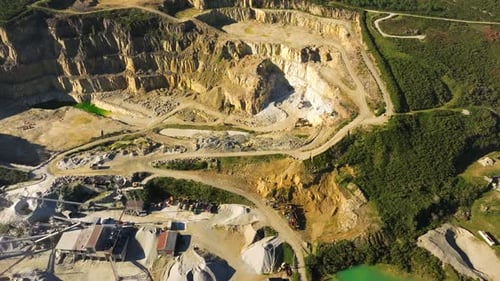 Open-cast Mining Extracting Rock From The Earth On A Sunny Day In Castriz, Spain. - aerial shot