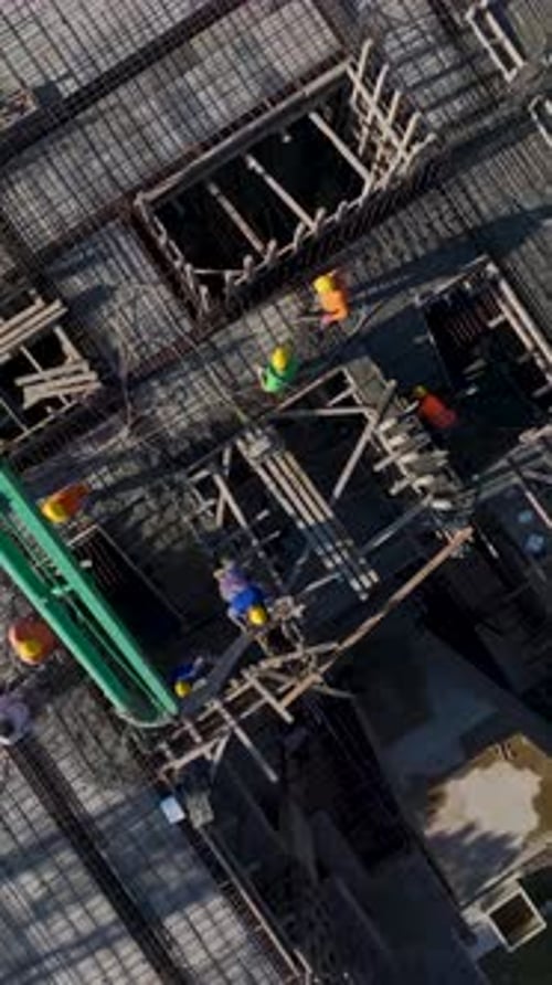 Vertical Video of Residential Construction With Workers Building Walls and Installing Metal Beams