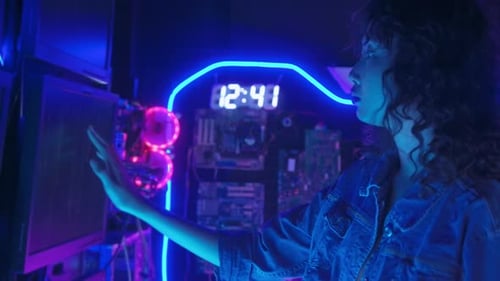 Young Adult Coding in Neon Lit Cyberpunk Room