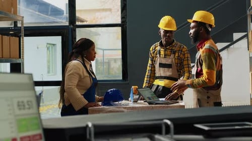 Workers Collaborate on Project in Warehouse