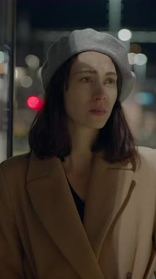 Woman in City Beret on Urban Platform at Night