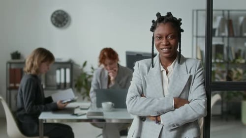 Confident Businesswoman Smiling in Modern Office Environment