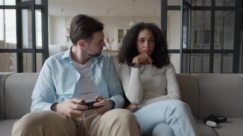 Couple Playing Video Games in Modern Home