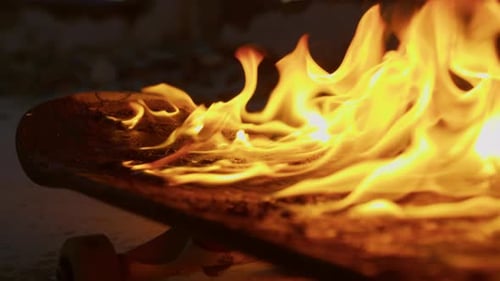 Skateboard Ablaze with Intense Fire at Sunset