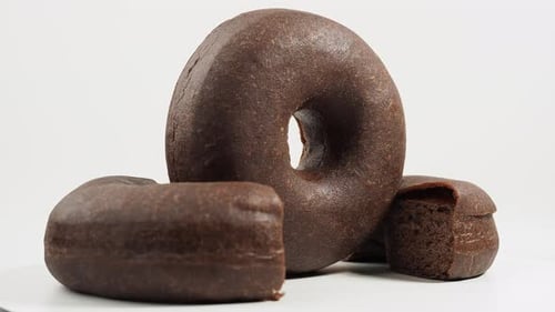 Three Chocolate Donuts on White Background Close Up