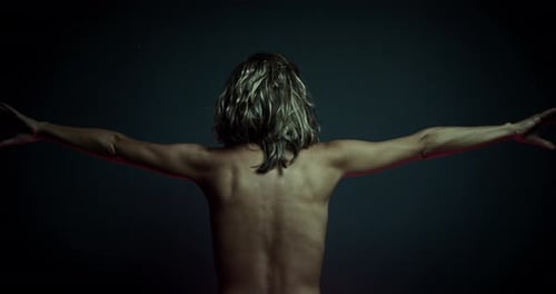 Woman's body and muscle's movements, nude back view. Cinematic 4K.