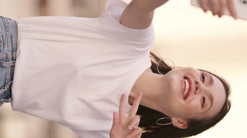 Vertical Vlogging Smiling Young Woman in Casual Clothes