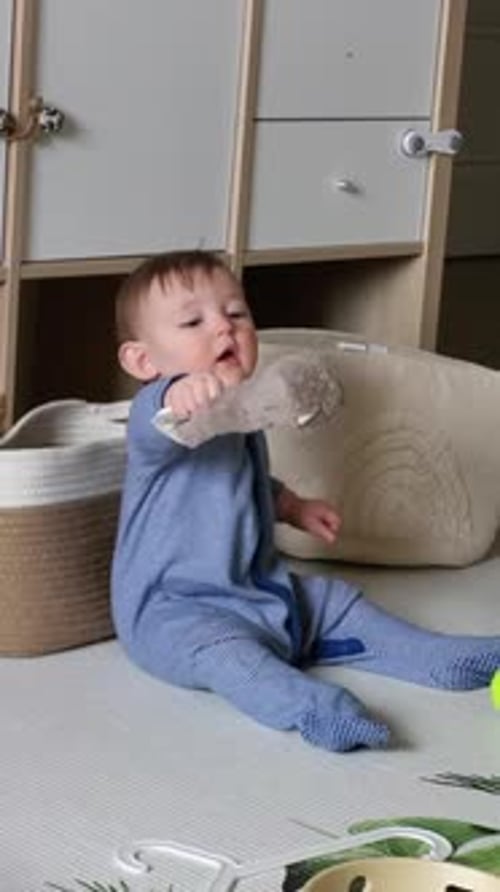 Baby Playing with Toy on the Floor