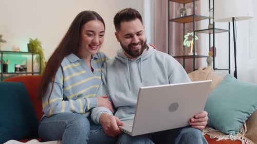 Young Couple Video Chatting Together at Home