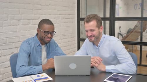 Two Men Video Conferencing in Office Setting