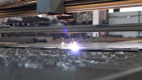 Plasma cutting of metal on a CNC machine. Manufacturing of industrial metal parts using a computer.