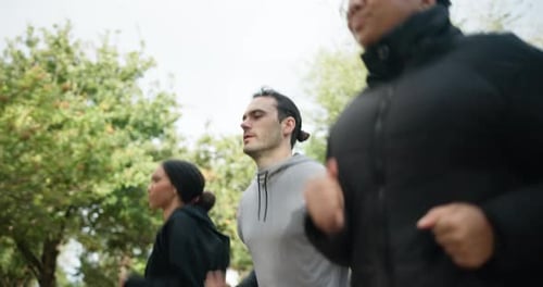 Training, woods and group of friends running together for outdoor exercise