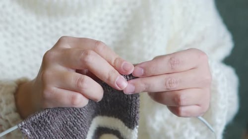 Close Up of Hands Knitting Warm Woolen Item