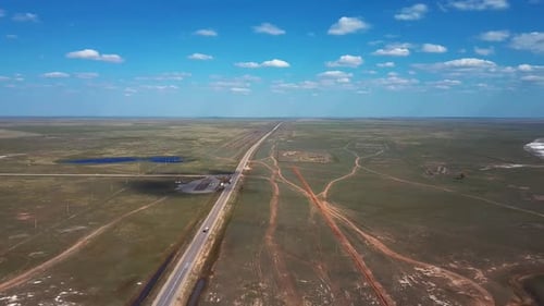 Highway In The Steppe With Passing Trucks