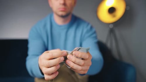 Man Counting US Dollar Bills or Paying in Cash