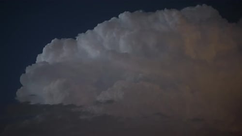 Storm Cloud Illuminated by Lightning at Night