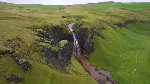 Aerial view of raudarfoss waterfall in canyon, Iceland.