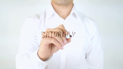 Adult Writes Saturday on Clear Surface with Marker