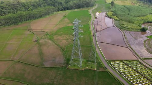 Orbit drone shot of high voltage electricity tower to distribute electricity - POI Drone Shot