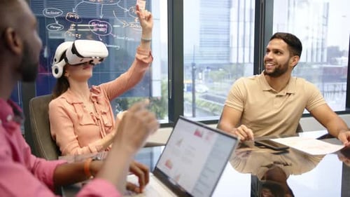 Using VR headset, woman in office meeting with multiracial colleagues, discussing project