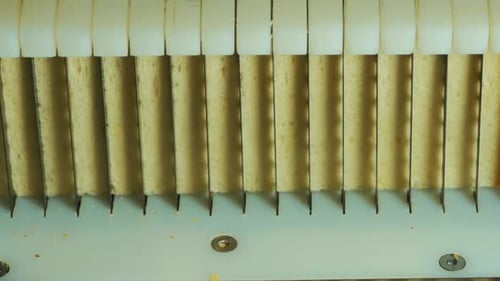 bread cutting cuts square bread. close up shot. breaks the bread into all its pieces.2