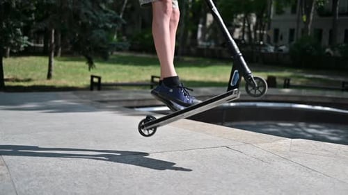 Boy jumping on a skateboard in a sport park, slow motion