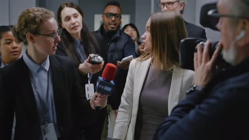 Woman Answers Questions at Press Conference Interview