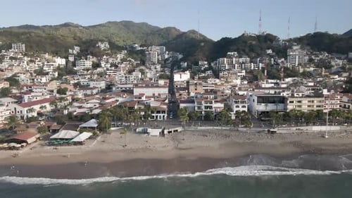 Drone footage unveils the vibrant scene of the Malecon Boardwalk in Puerto Vallarta, Mexico. This bu