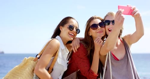 Three Young Women Taking Selfie at the Beach