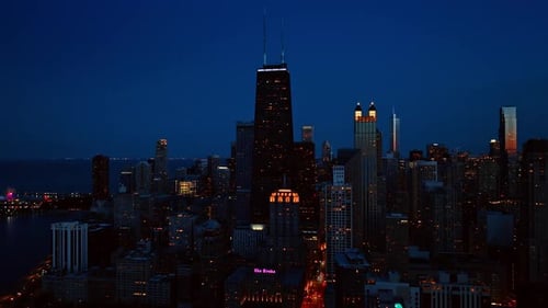 Chicago switches on the lights in the streets and buildings at dusk.