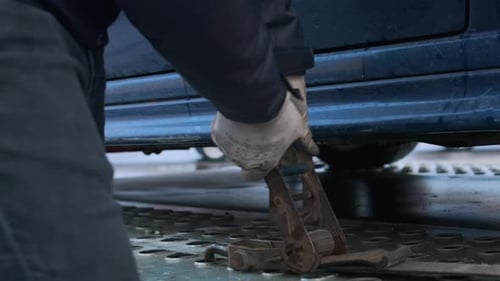 Hands of Man Fixing Trailer on Car with Hitch Lock Handle
