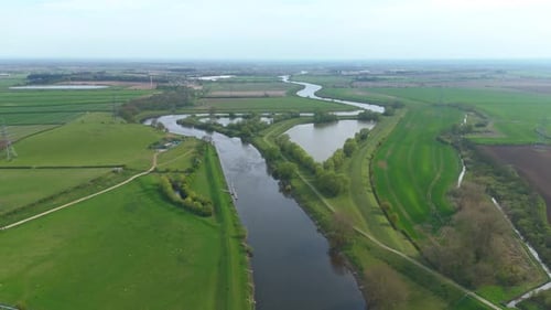 Aerial Drone View of River Bridge Crossing in Rural England with Green Fields and Scenic Countryside