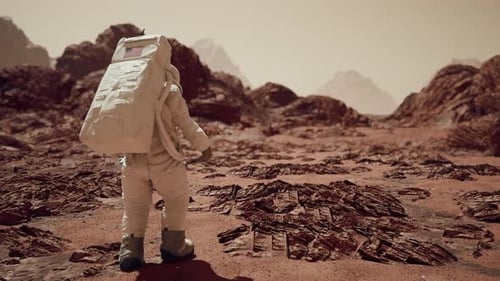Astronaut Walking On Mars Surface Through Rocky Terrain And Martian Sand 2