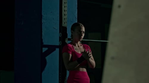 Girl Warming Up Hands and Wrists during Sports Training at Gym
