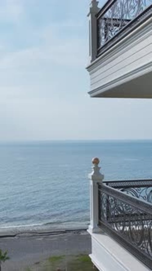 Vertical Video Beautiful Facade with Balconies Overlooking the Blue Mediterranean Sea in a Bright