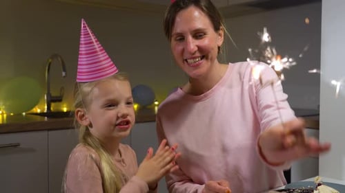 Mother and Child Celebrating Birthday with Sparklers