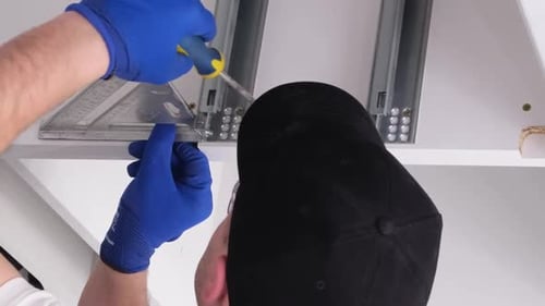 A Professional Master During the Installation of Kitchen Furniture Vertical Video