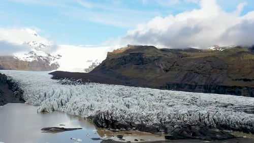 Flyover drone shot on Svinafellsjokull glacier outlet in Vatnajokull National Park in South Iceland