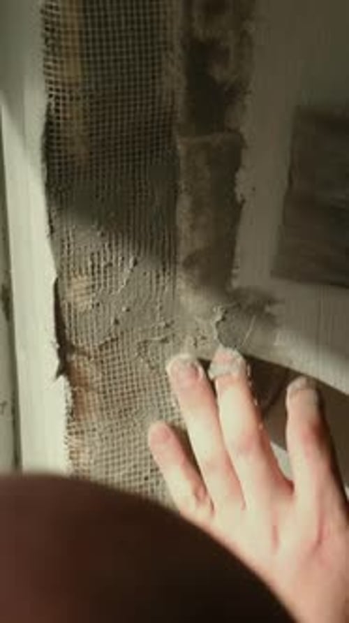 Vertical Video Person Plastering Wall Using Fiberglass Mesh