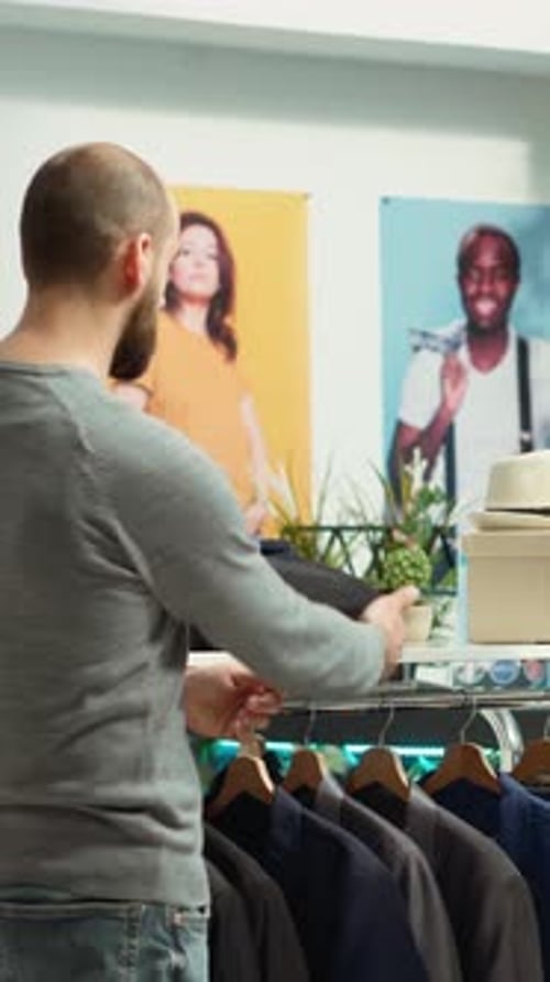 Man Browsing Suits in Retail Store