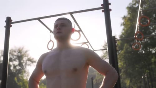 Muscular Man Preparing for Outdoor Gym Workout
