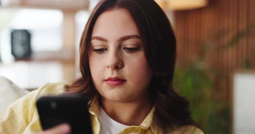 Phone, reading and social media with woman on sofa in living room of home for post or update