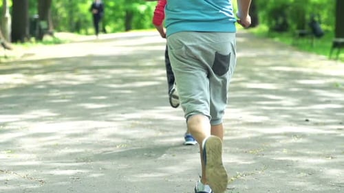 Active Couple Jogging In The Park, Super Slow Motion